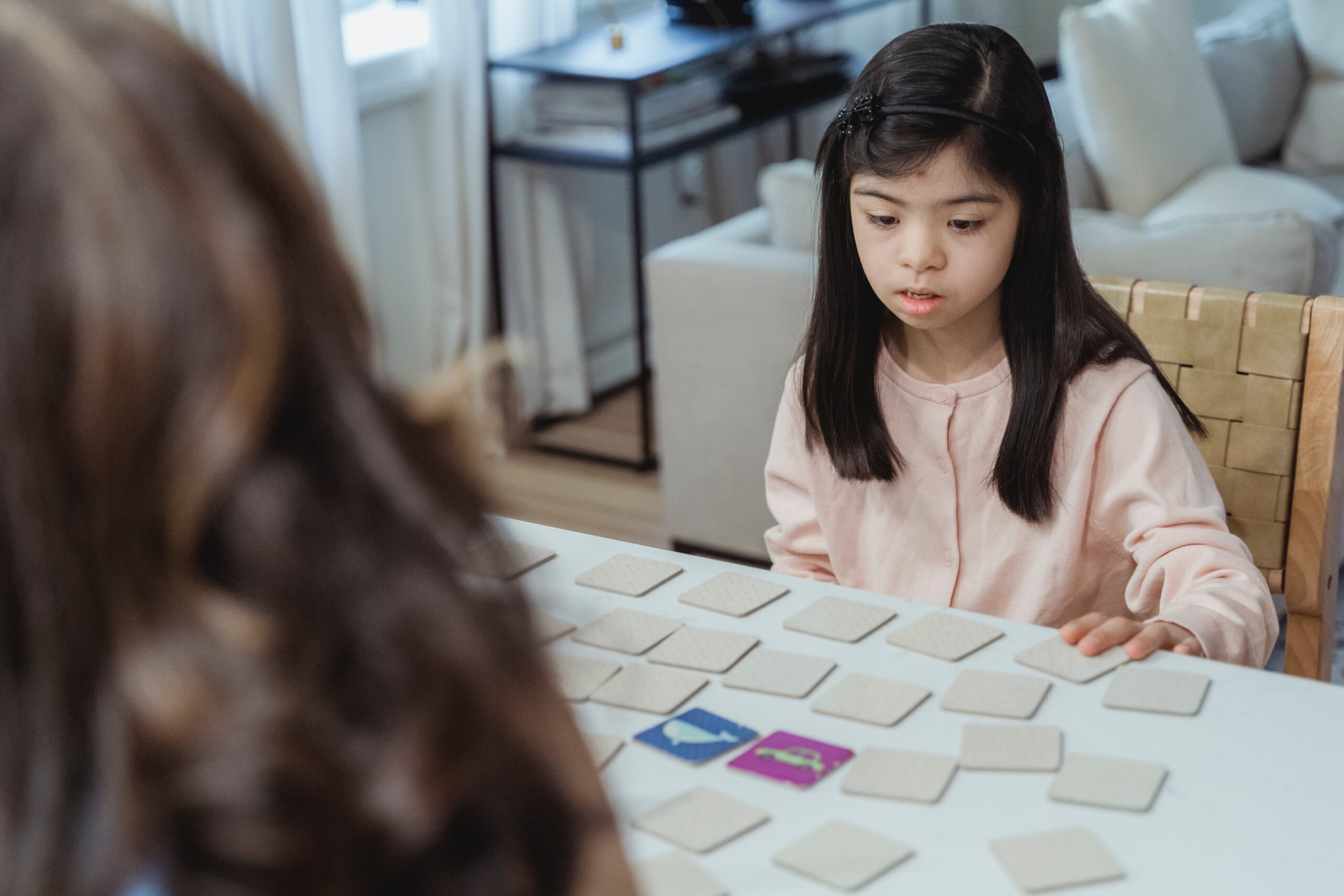 Girl playing cards with therapist